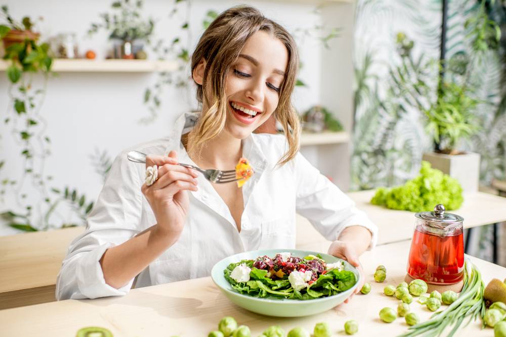 Young,Woman,Eating,Healthy,Food,Sitting,In,The,Beautiful,Interior