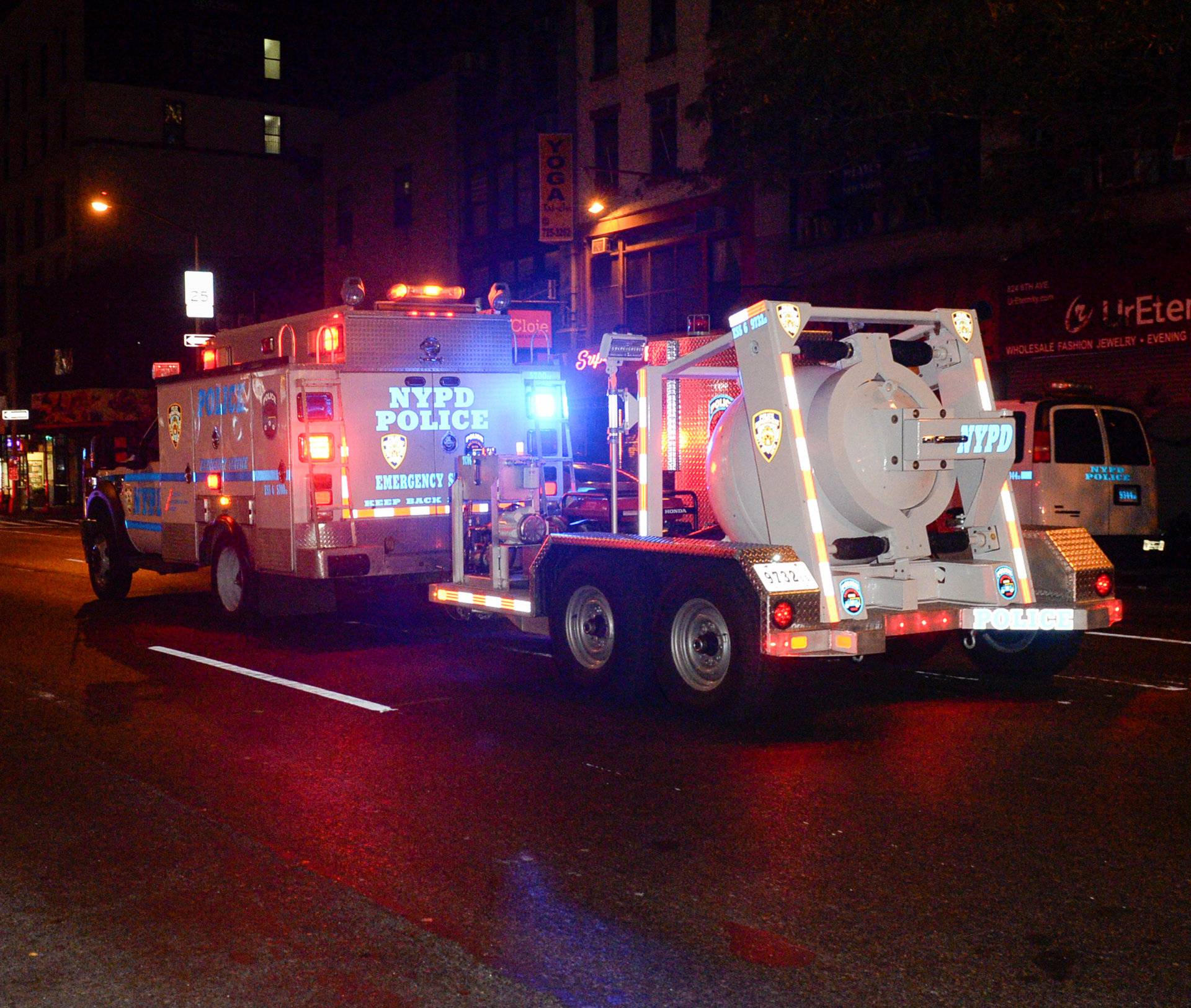 A police truck tows spherical chamber carrying second explosive device from near site of explosion in New York