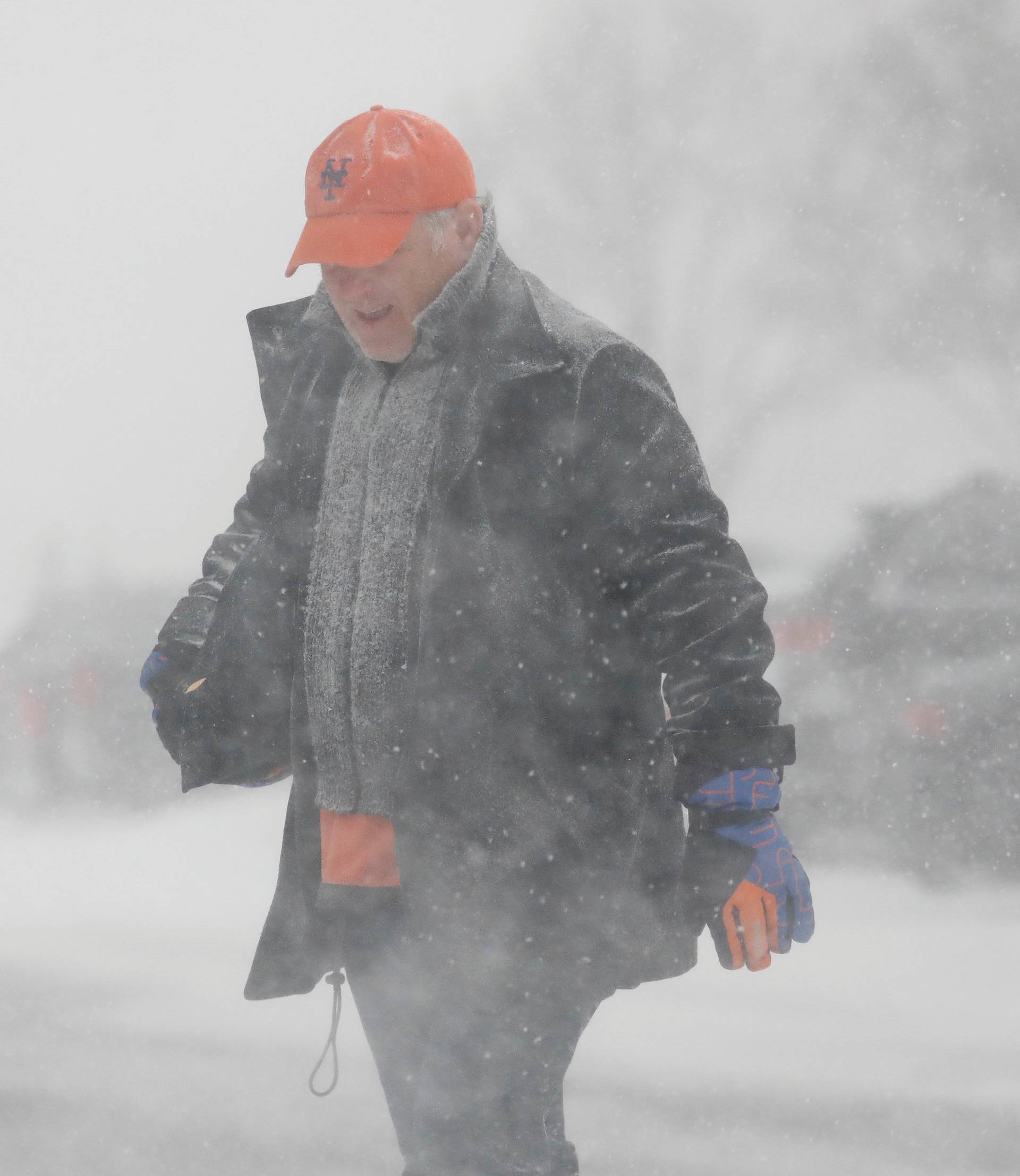 A man crosses the street during a blizzard in Long Beach, New York