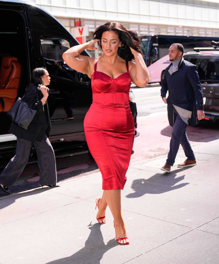 EXCLUSIVE: Ashley Graham Dazzles in a Red Dress While Arriving at Planet Hollywood in New York City.