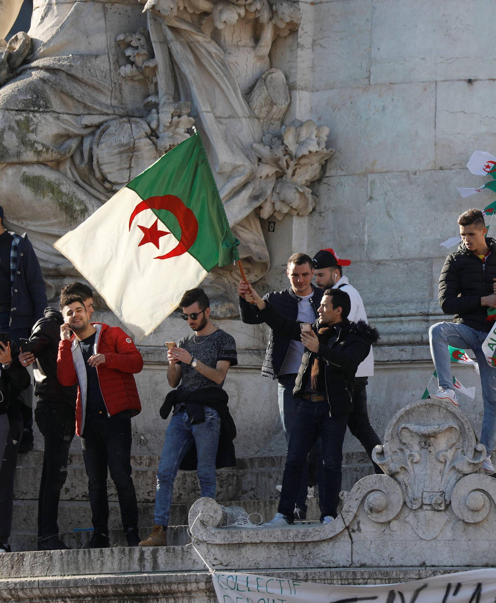 Demonstrators gather around the Monument to the Republic during a protest against President Abdelaziz Bouteflika in Paris