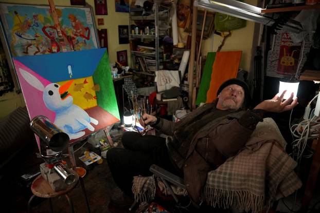 Ukrainian artist works at his studio during a power blackout in Kyiv