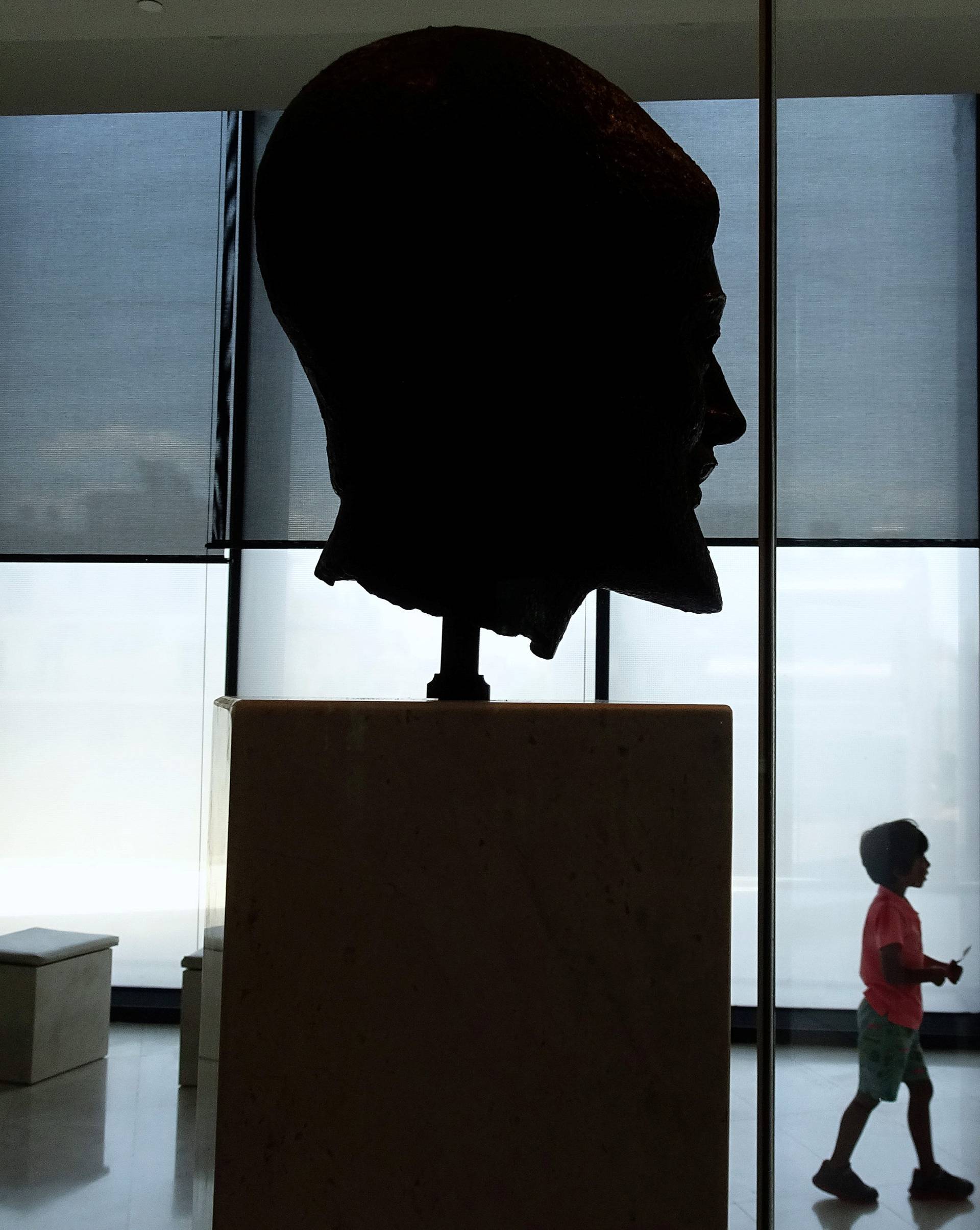 A young tourist walks inside the new Acropolis museum in Athens