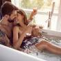 beautiful couple drinking champagne in the bathtub
