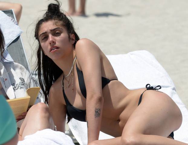 Lourdes Leon relaxes on the beach with a male friend