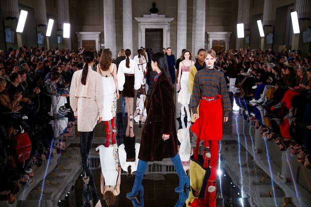 Models present creations at the Victoria Beckham catwalk show during London Fashion Week in London