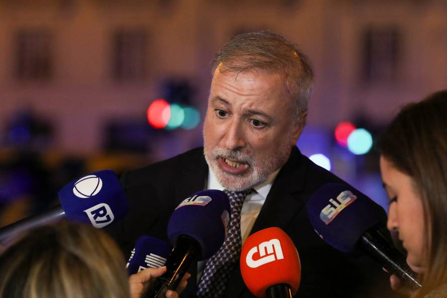 First responders work at the site of a funicular accident in Lisbon