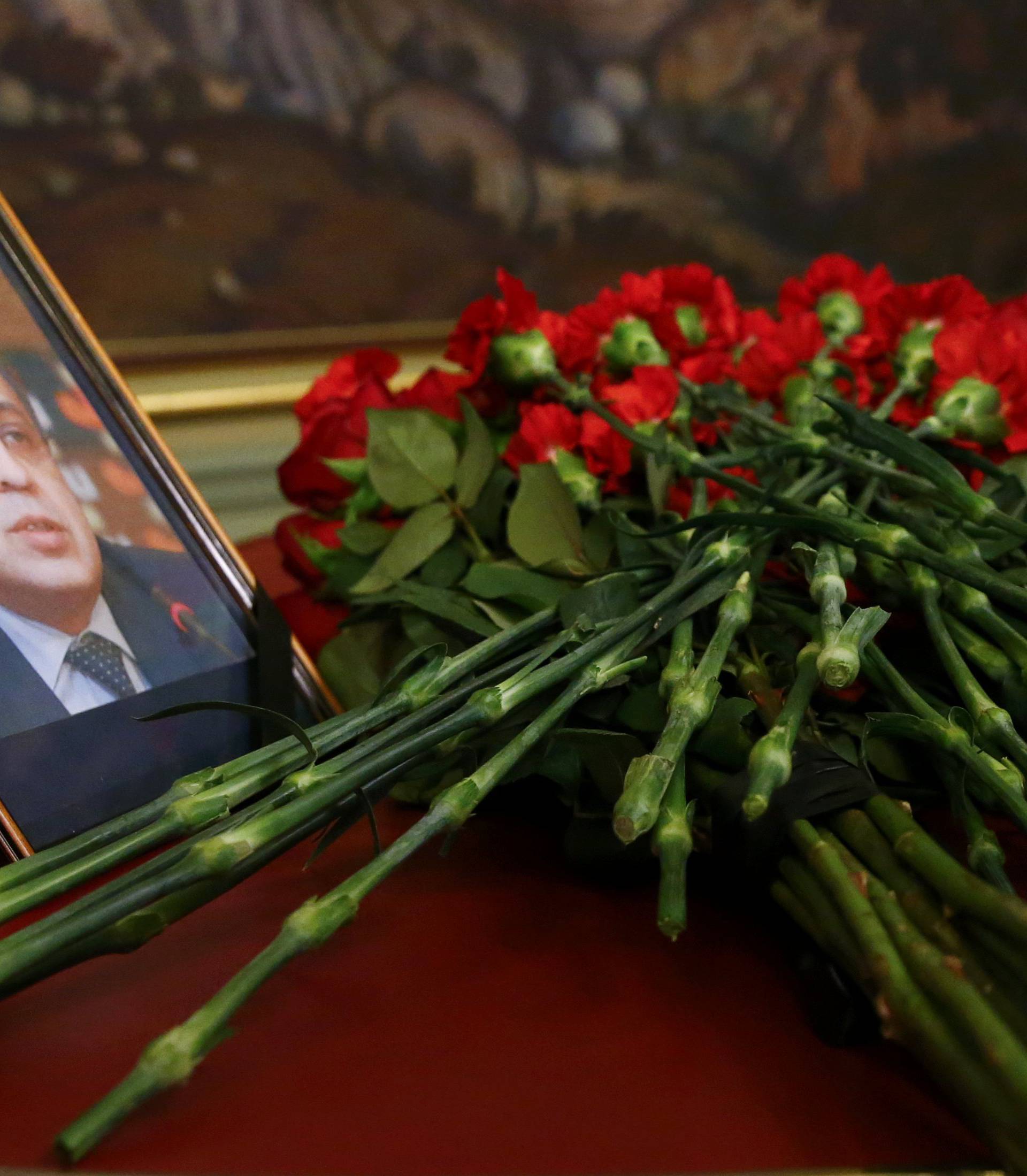 Flowers are placed near a portrait of murdered Russian ambassador to Turkey Karlov during a meeting of Russian Foreign Minister Lavrov with his Turkish counterpart Cavusoglu in Moscow