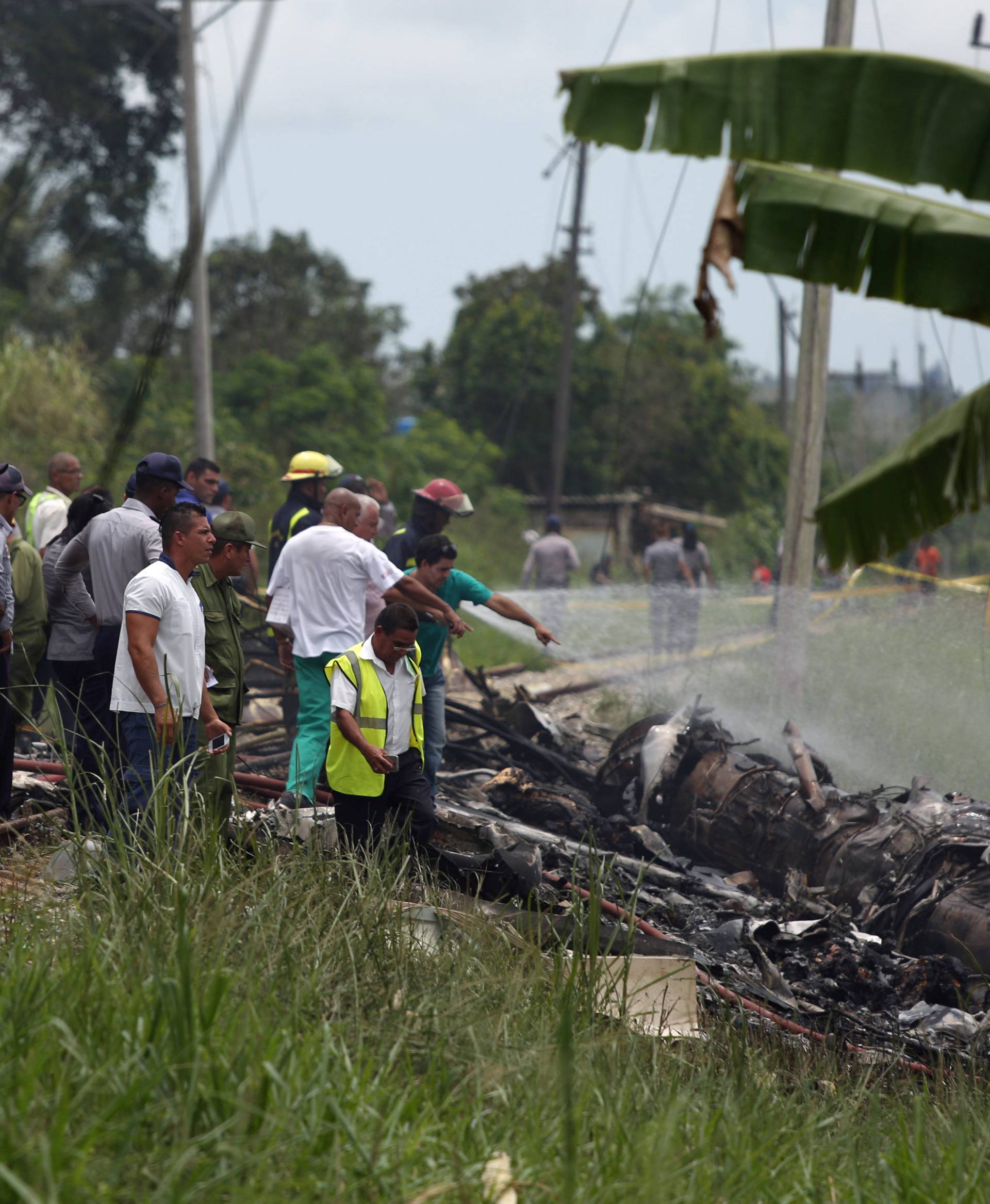 Rescue team members work in the wreckage of a Boeing 737 plane that crashed in the agricultural area of Boyeros