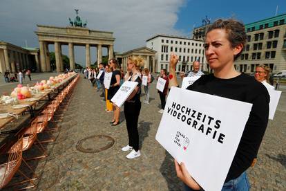 People working in the wedding industry protest against restrictions in the business in front of the Brandenburg Gate, following the coronavirus disease (COVID-19) outbreak in Berlin