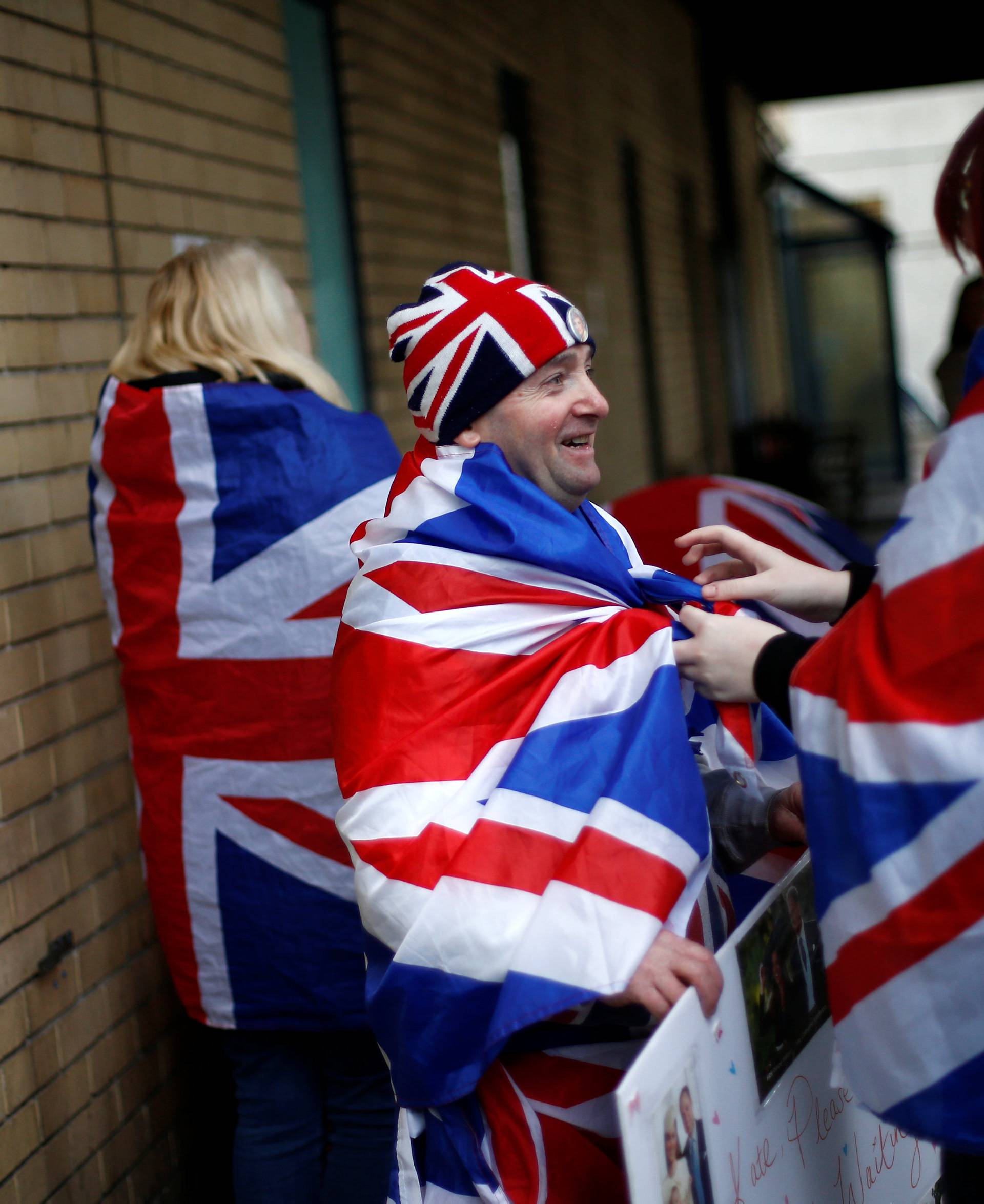 Fans of Britain's royal family stand outside the hospital where Catherine, the Duchess of Cambridge, is due to give birth, in London