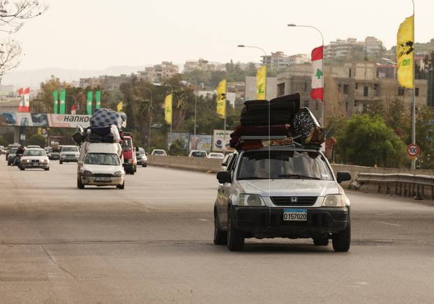 Displaced people make their way as they return to their homes after a 10-day ceasefire between Lebanon and Israel went into effect, near Sidon