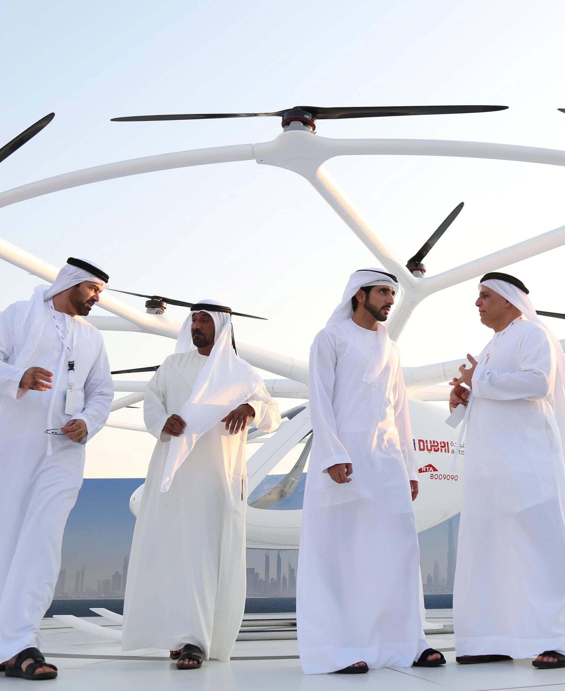 Dubai Crown Prince Sheikh Hamdan bin Mohammed bin Rashid Al Maktoum stands in front of the flying taxi in Dubai