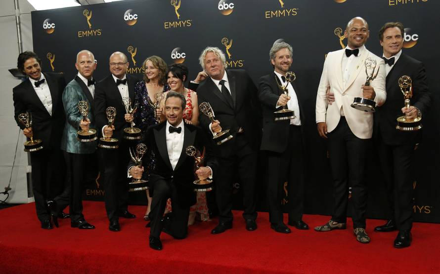 Producer Ryan Murphy poses with cast and crew backstage at the 68th Primetime Emmy Awards in Los Angeles