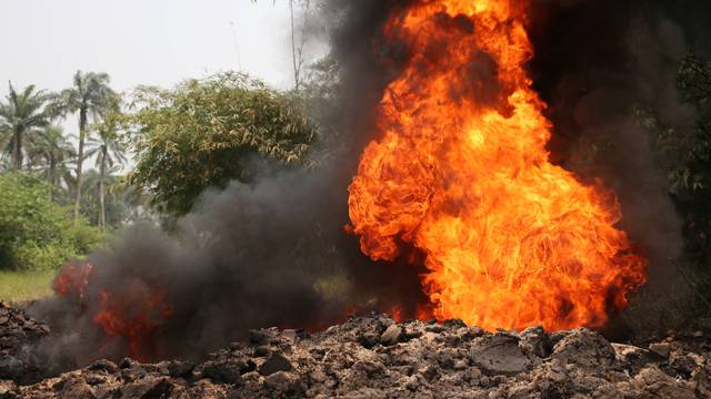 Fire burns on the Shell Petroleum Development Company Trans Niger pipeline at Mogho