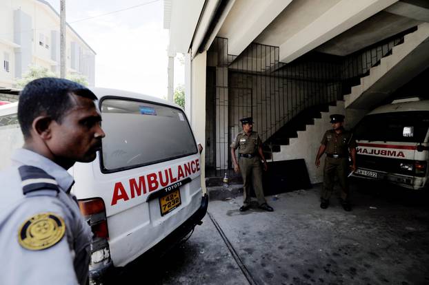 A police ambulance carrying casualties enters the police mortuary in Colombo