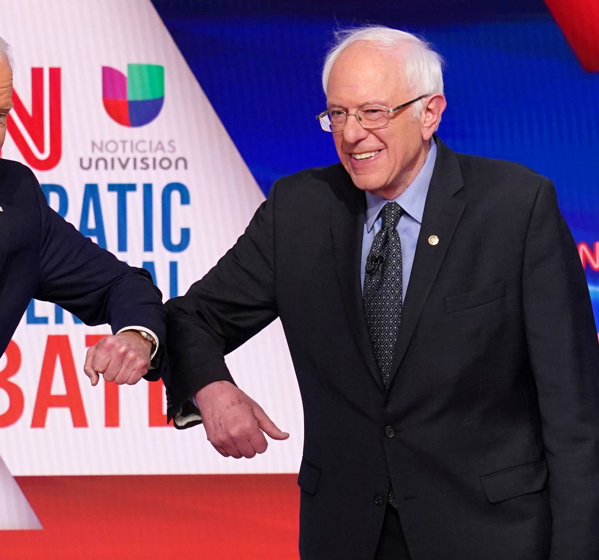 FILE PHOTO: Democratic U.S. presidential candidates Senator Bernie Sanders and former Vice President Joe Biden at the 11th Democratic candidates debate of the 2020 U.S. presidential campaign in Washington