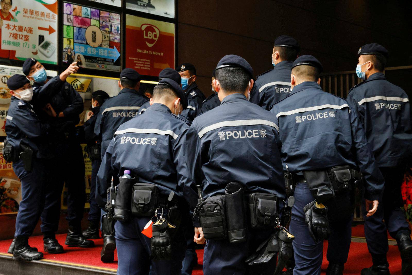 FILE PHOTO: Police are seen outside the Stand News office building, after six people were arrested "for conspiracy to publish seditious publication" according to Hong Kong's Police National Security Department, in Hong Kong
