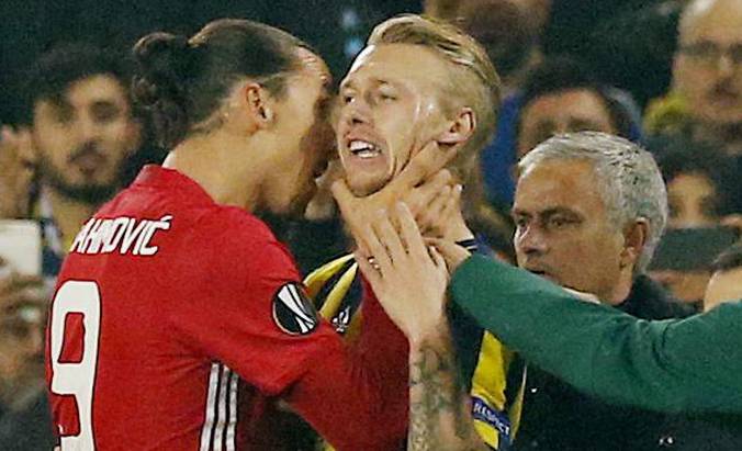Manchester United's Zlatan Ibrahimovic clashes with Fenerbahce's Simon Kjaer as manager Jose Mourinho looks on