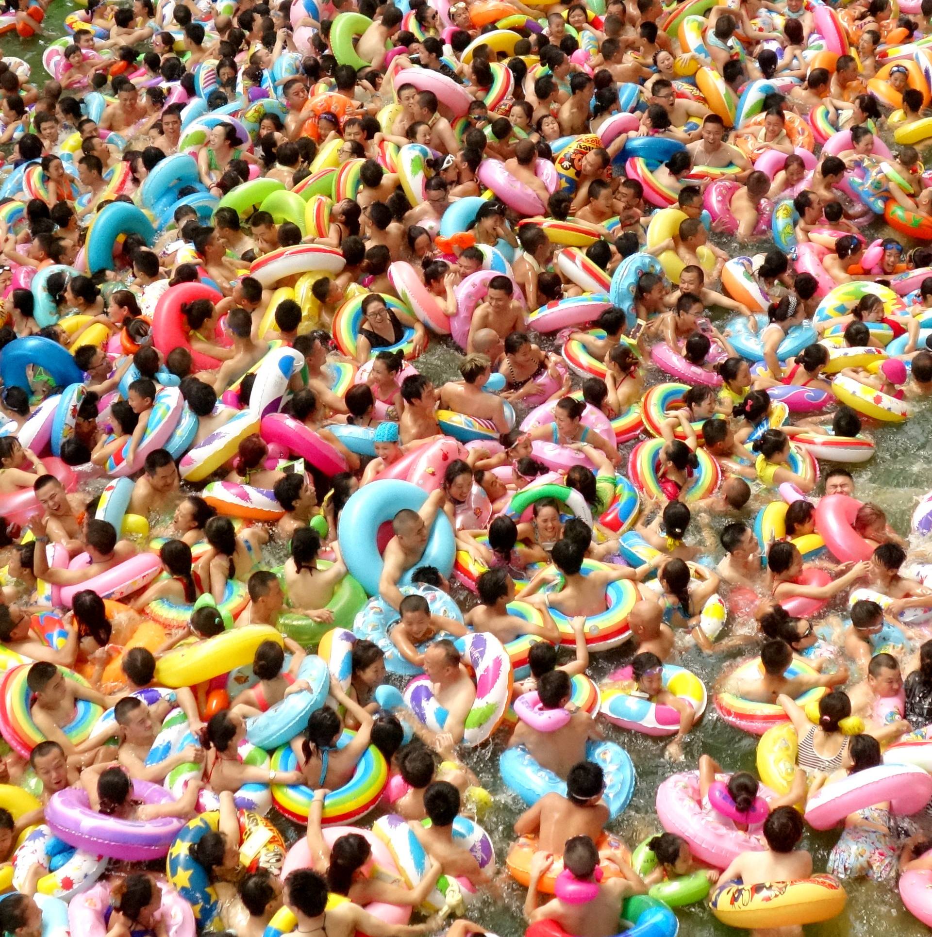 People cool off at a swimming pool in Daying county
