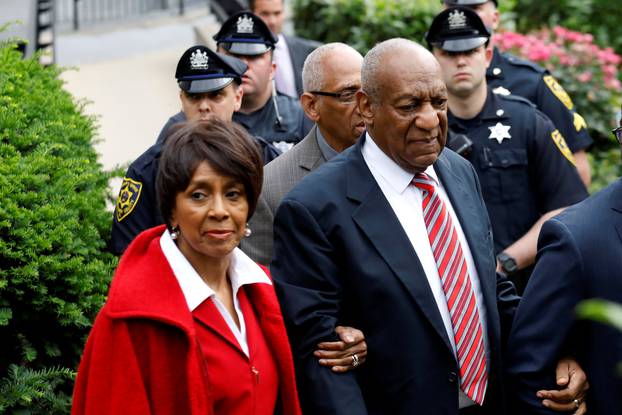 Actor and comedian Bill Cosby leaves with John Atchison and Sheila Frazier after the third day of Cosby