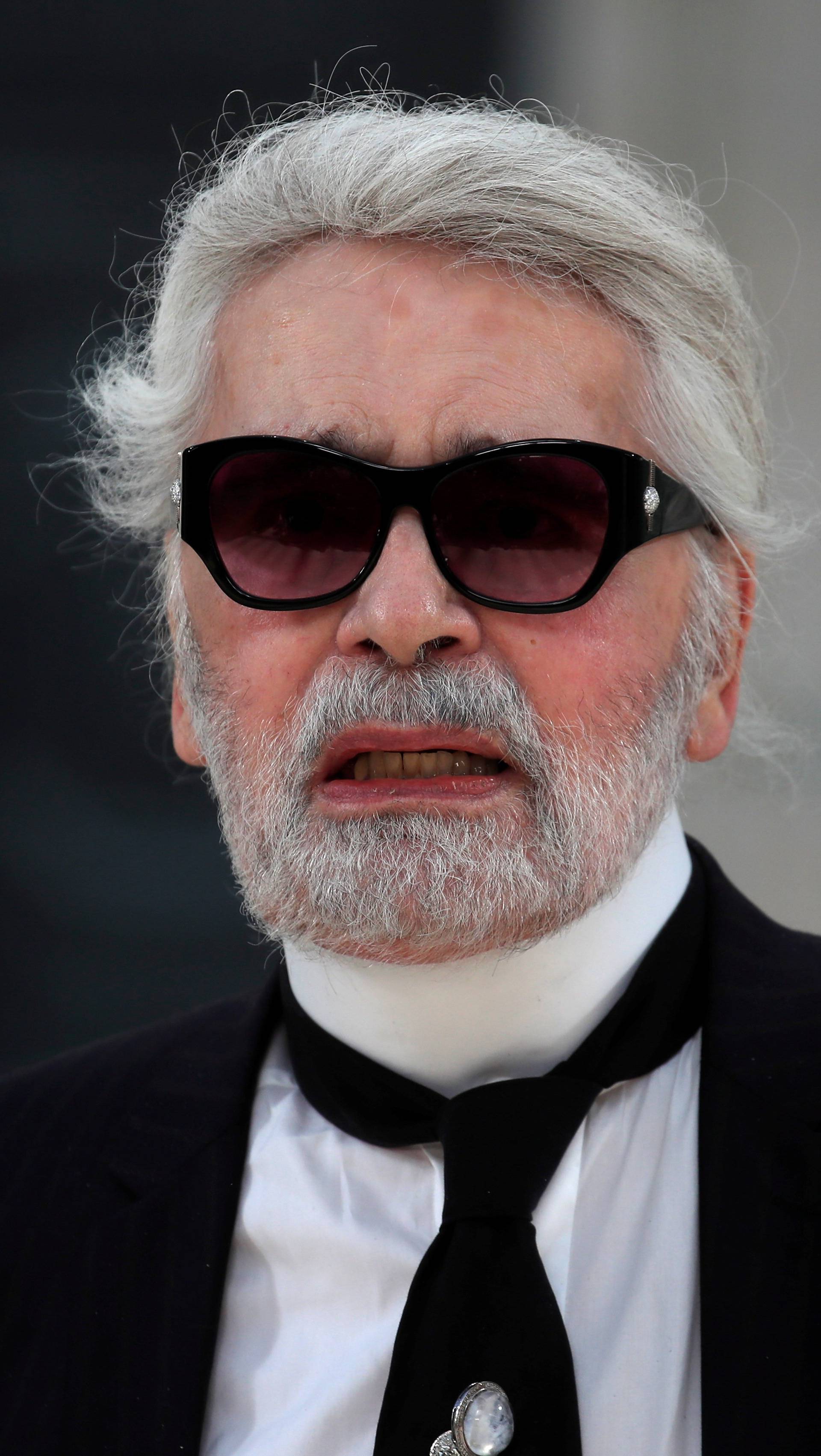 German designer Karl Lagerfeld appears at the end of his Haute Couture Fall/Winter 2018/2019 collection show for fashion house Chanel at the Grand Palais in Paris