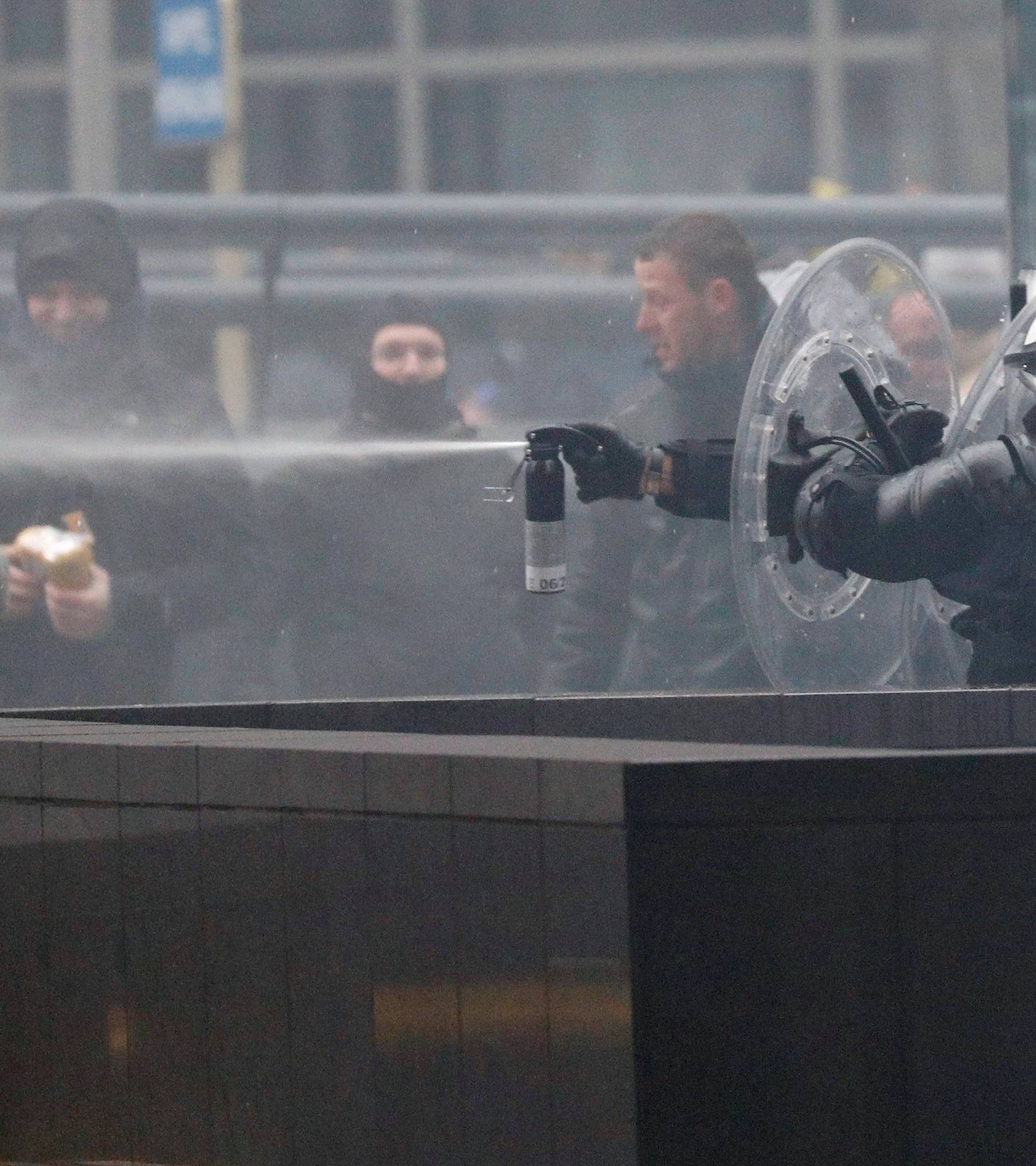 Police officers use tear gas during a protest against Marrakesh Migration Pact in Brussels