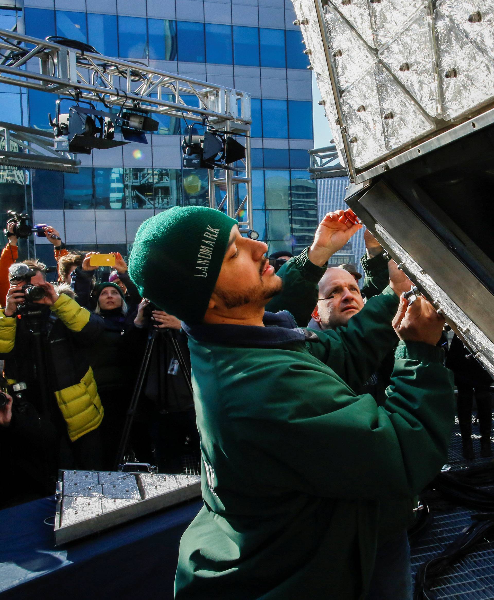 Workers install Waterford Crystal triangles on the Times Square New Year's Eve Ball on the roof of One Times Square in the Manhattan borough of New York