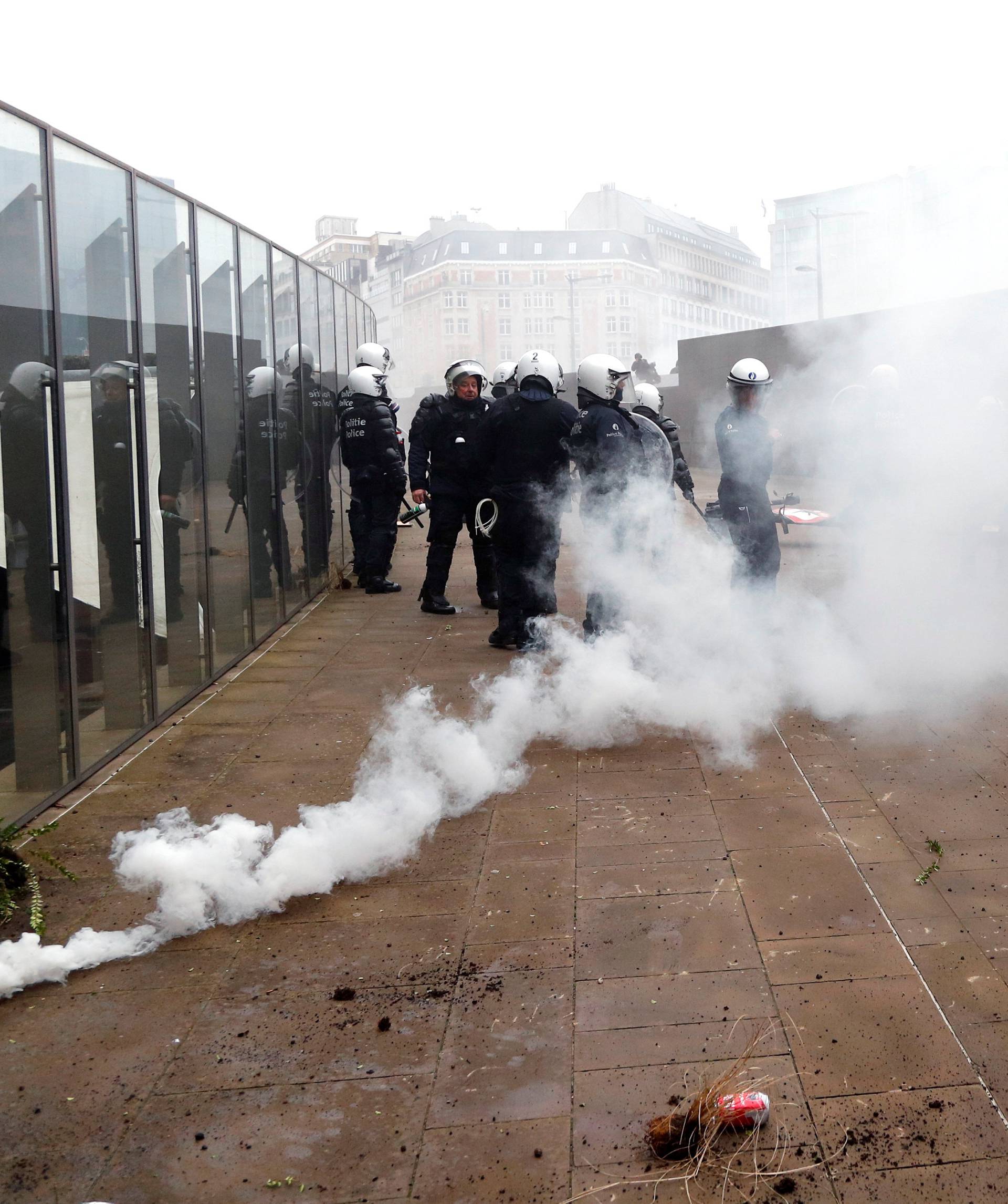 Police officers use tear gas during a protest against Marrakesh Migration Pact in Brussels