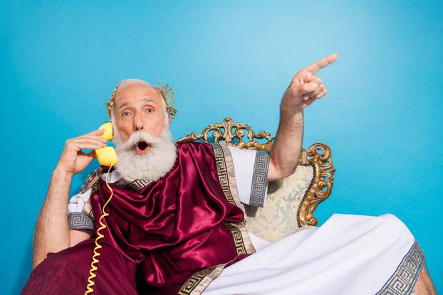 Photo of shocked theater actor wearing traditional crown mantle advise empty space isolated on blue color background