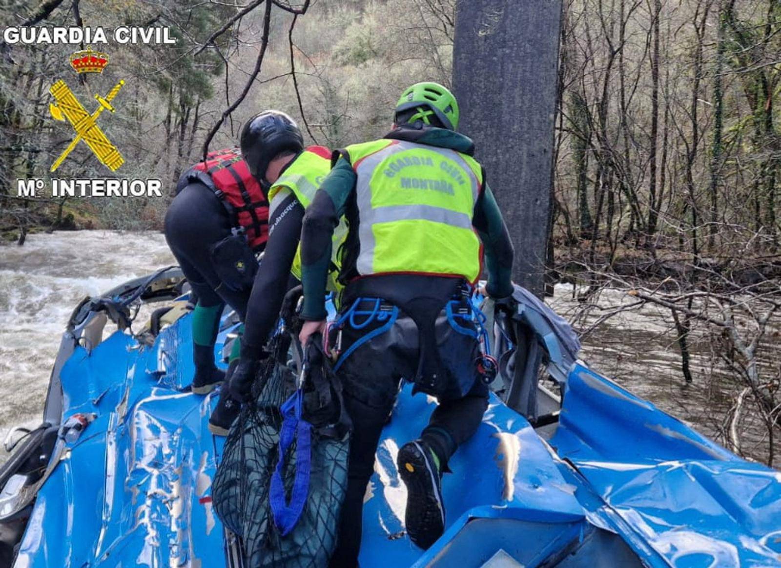 embers of the Spanish Civil Guard work at the scene of an accident where a passenger bus plunged off a bridge into the river in northwestern Spain