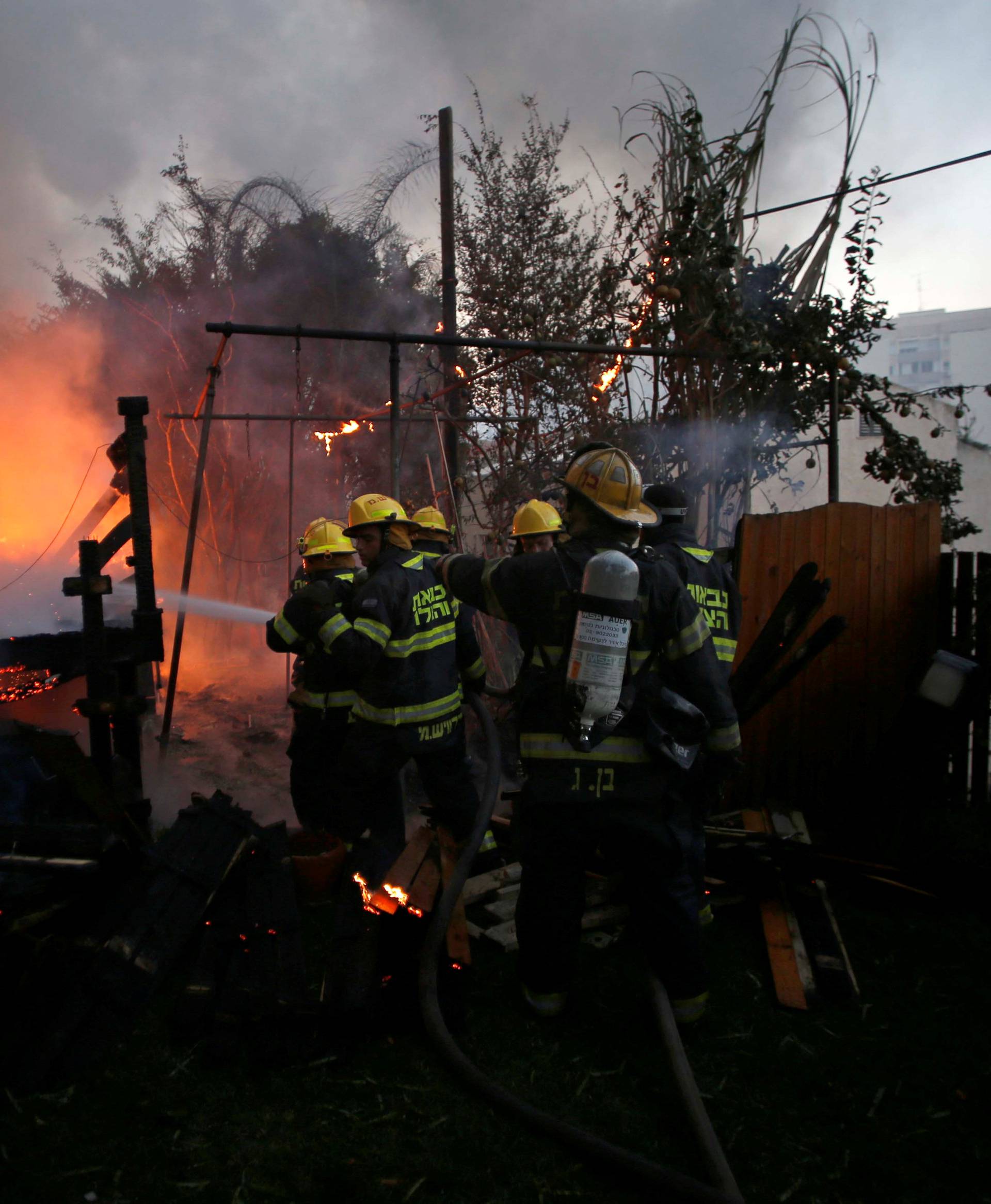 Firefighters work as a wildfire burns in the northern city of Haifa, Israel 