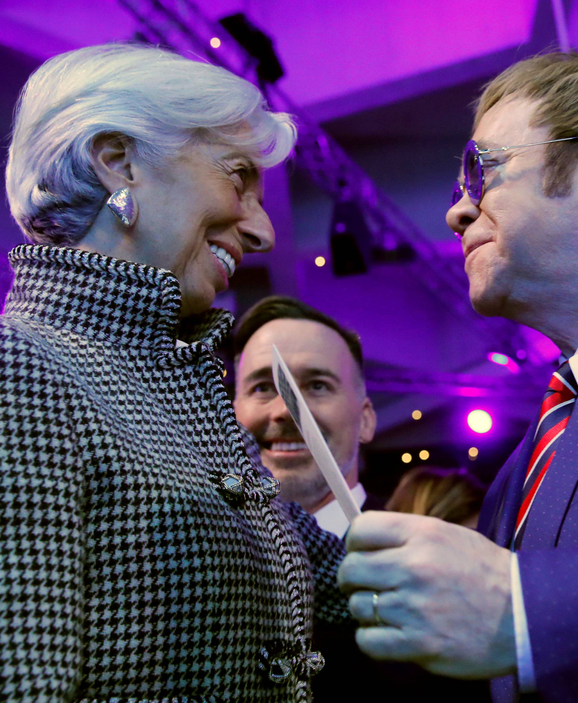 Singer Elton John talks with Christine Lagarde, Managing Director of the International Monetary Fund (IMF), at the Crystal Awards ceremony of the annual meeting of the World Economic Forum (WEF) in Davos