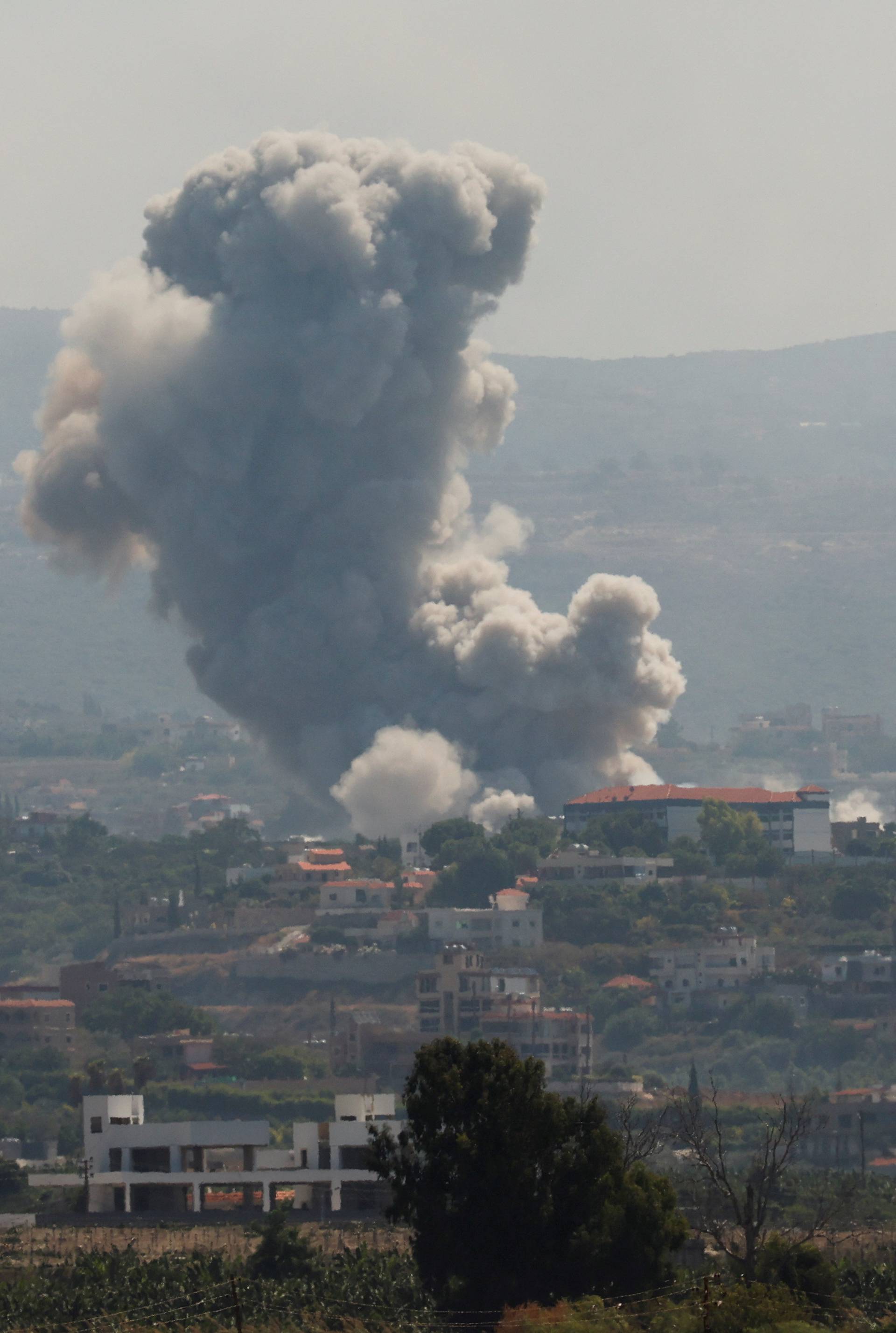 Smoke billows over southern Lebanon following Israeli strikes, as seen from Tyre, southern Lebanon