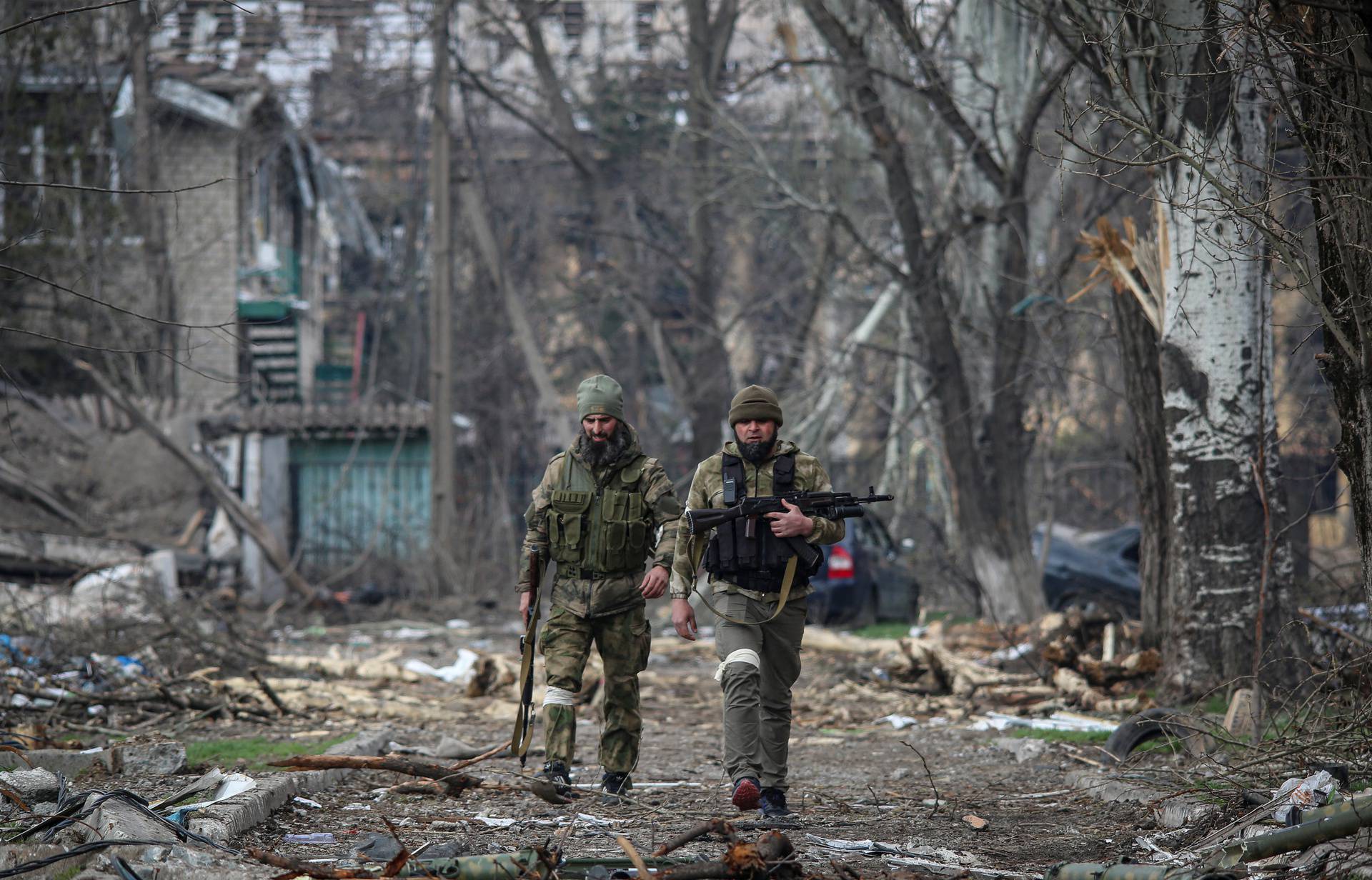 Service members from Chechen Republic walk during fighting in Ukraine-Russia conflict in Mariupol