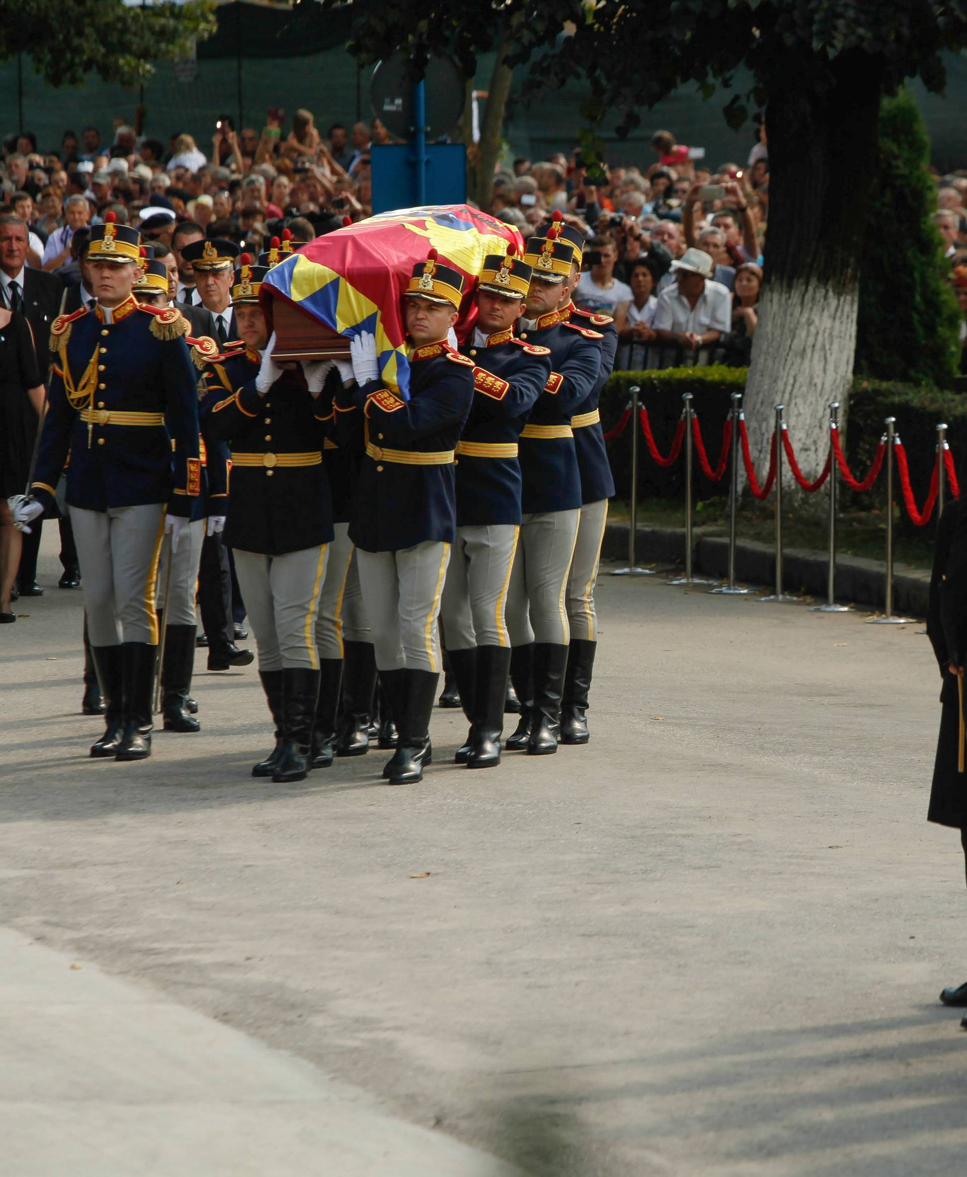 Romanian honor guard soldiers carry the coffin of the late Anne of Romania, wife of Romania's former King Michael, while arriving at the place of burial in Curtea de Arges