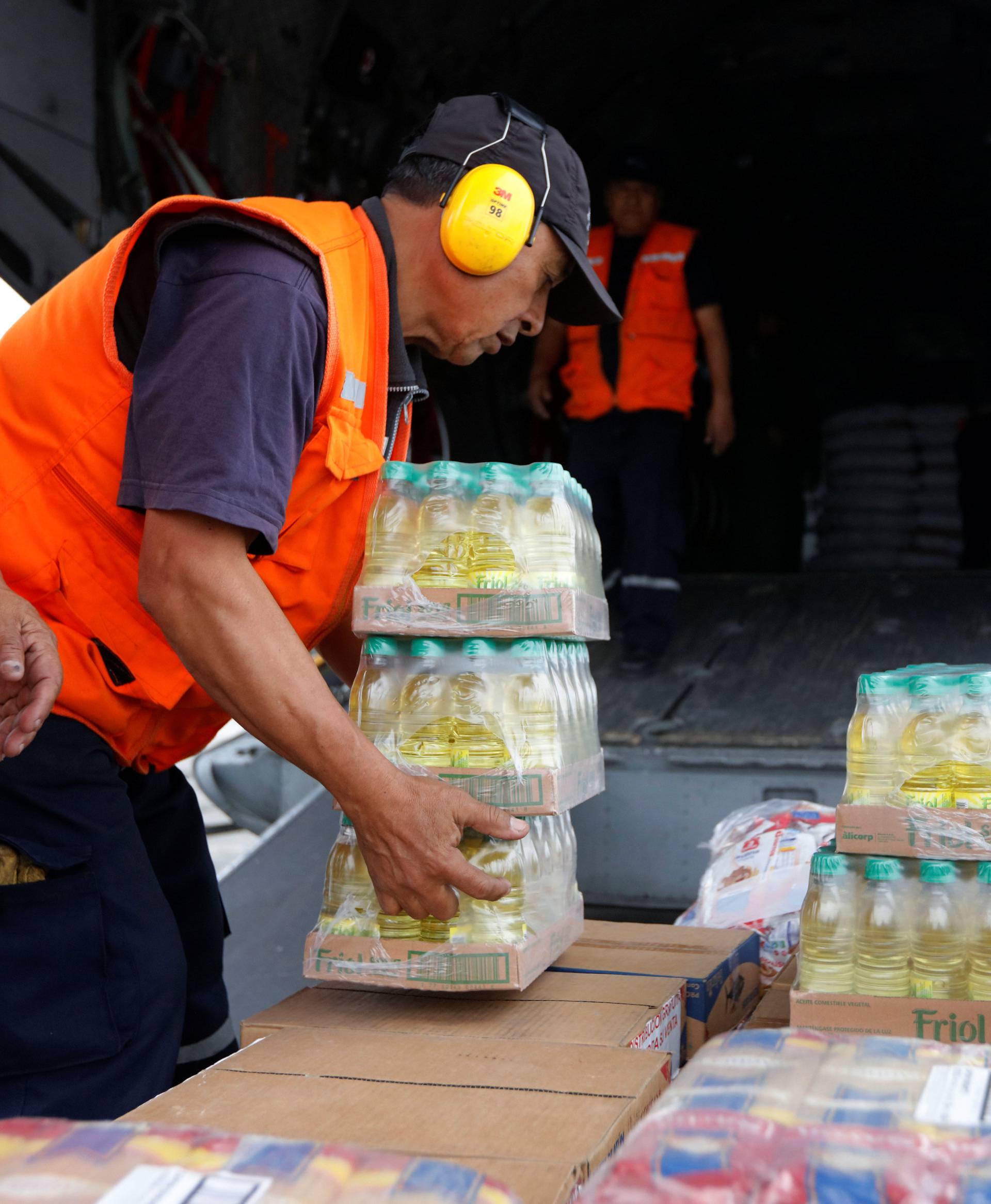 Members of Peru's National Institute of Civil Defense and Peru's Air Force load a cargo plane with aid to be delivered to the Caylloma province of the Andean region Arequipa after a 5.3 magnitude shallow earthquake rocked the region, in Lima