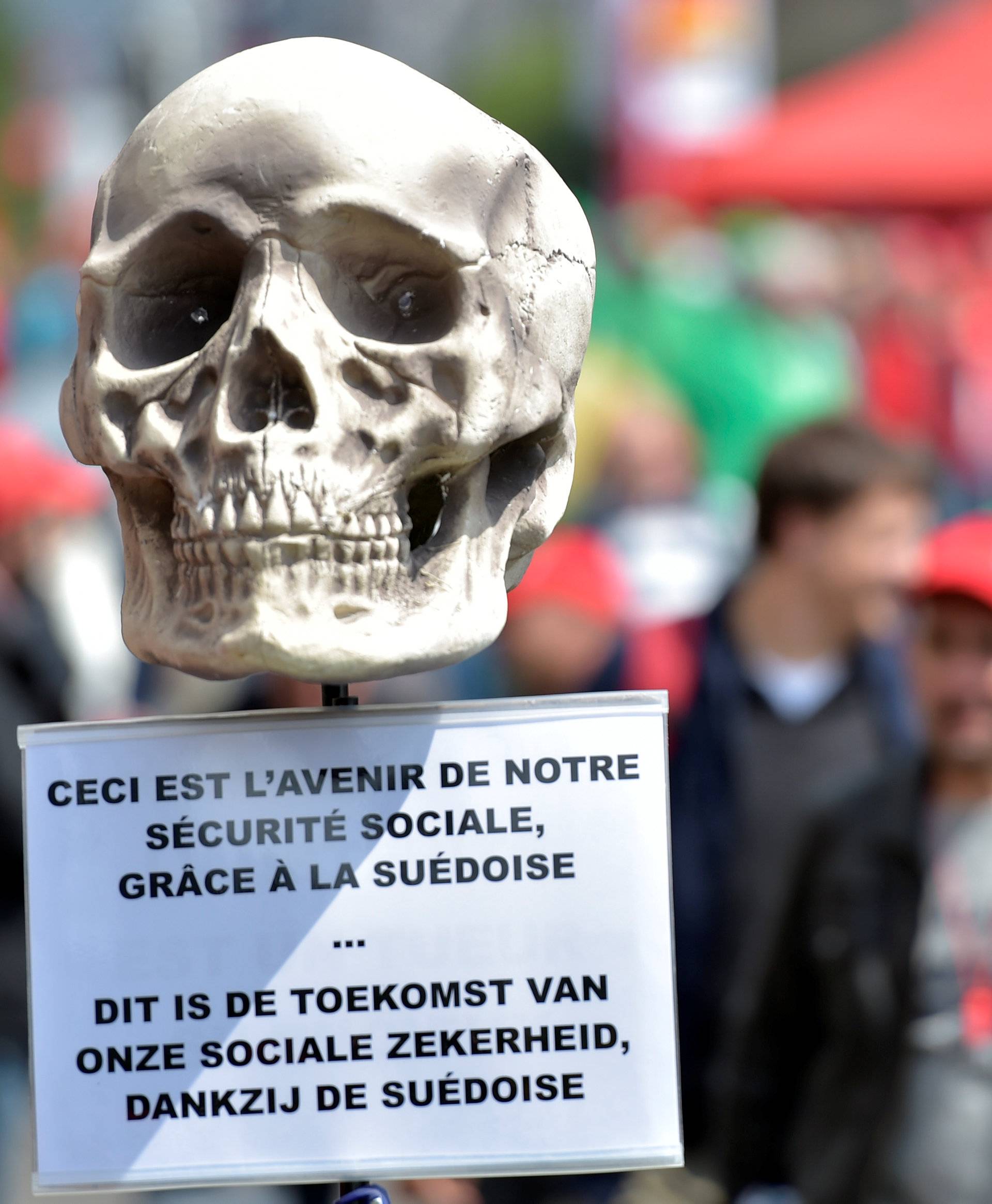 Demonstrators, protesting against government reforms and cost-cutting measures, march in central Brussels