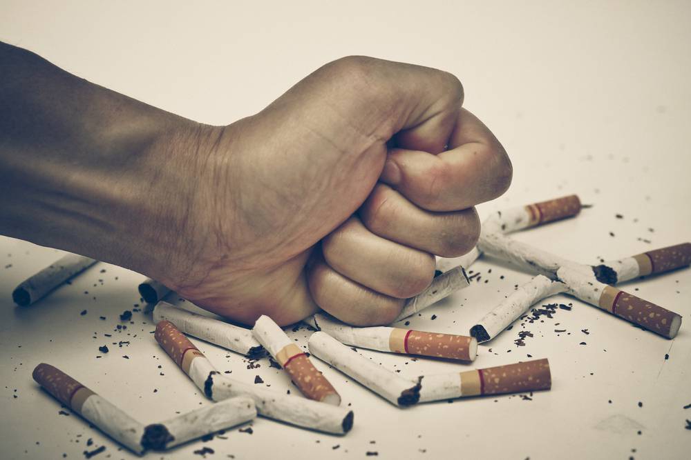 Male,Hand,Destroying,Cigarettes,-,Stop,Smoking,Concept