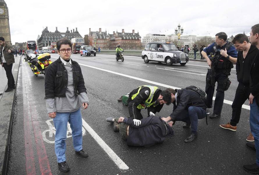 Injured people are assisted after an incident on Westminster Bridge in London