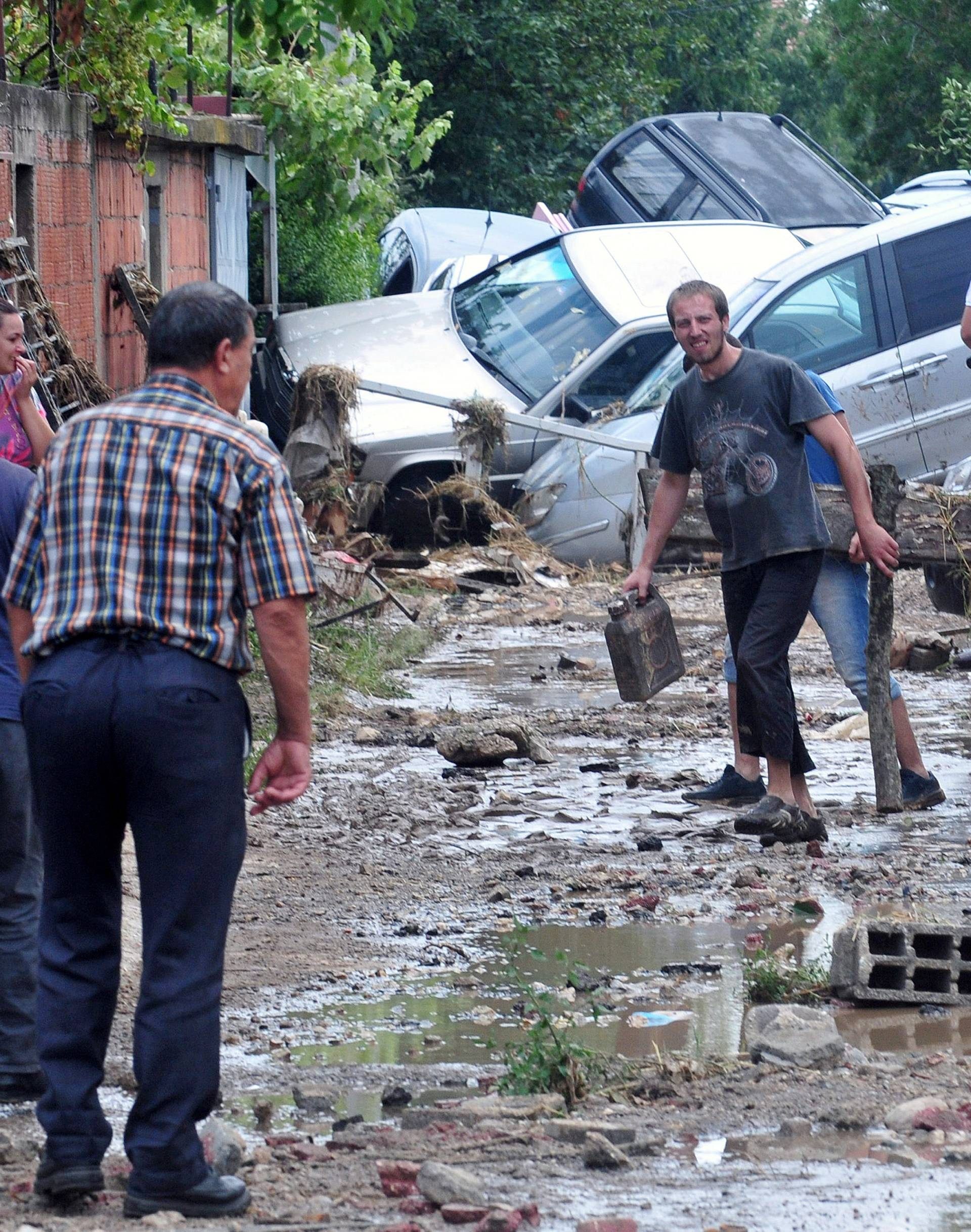 People walk on the streets after heavy floods in Cento near Skopje