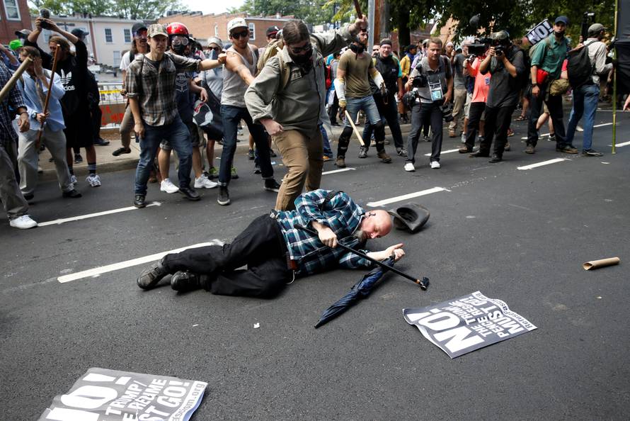 A man is down during a clash between members of white nationalist protesters and a group of counter-protesters in Charlottesville