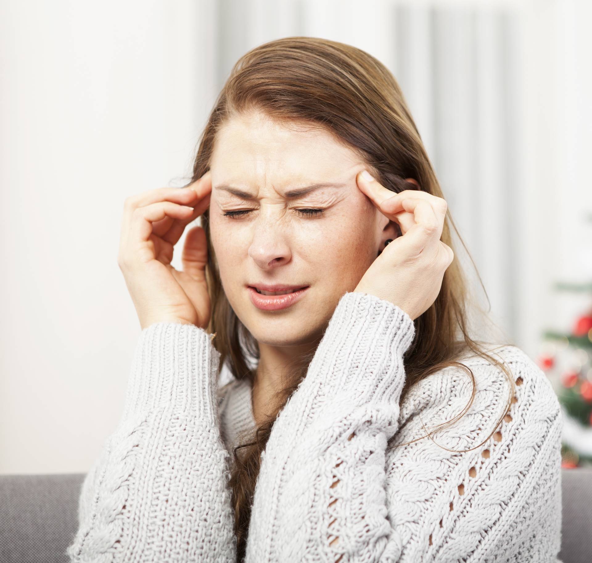 young girl has headache of christmas stress