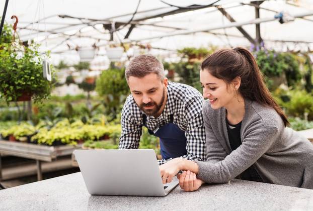 Female,Business,Owner,And,Gardener,Looking,At,Order,In,Laptop,