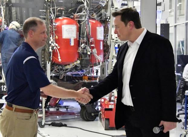 NASA Administrator Jim Bridenstine and SpaceX Chief Engineer Elon Musk shake hands after a tour of SpaceX headquarters in Hawthorne