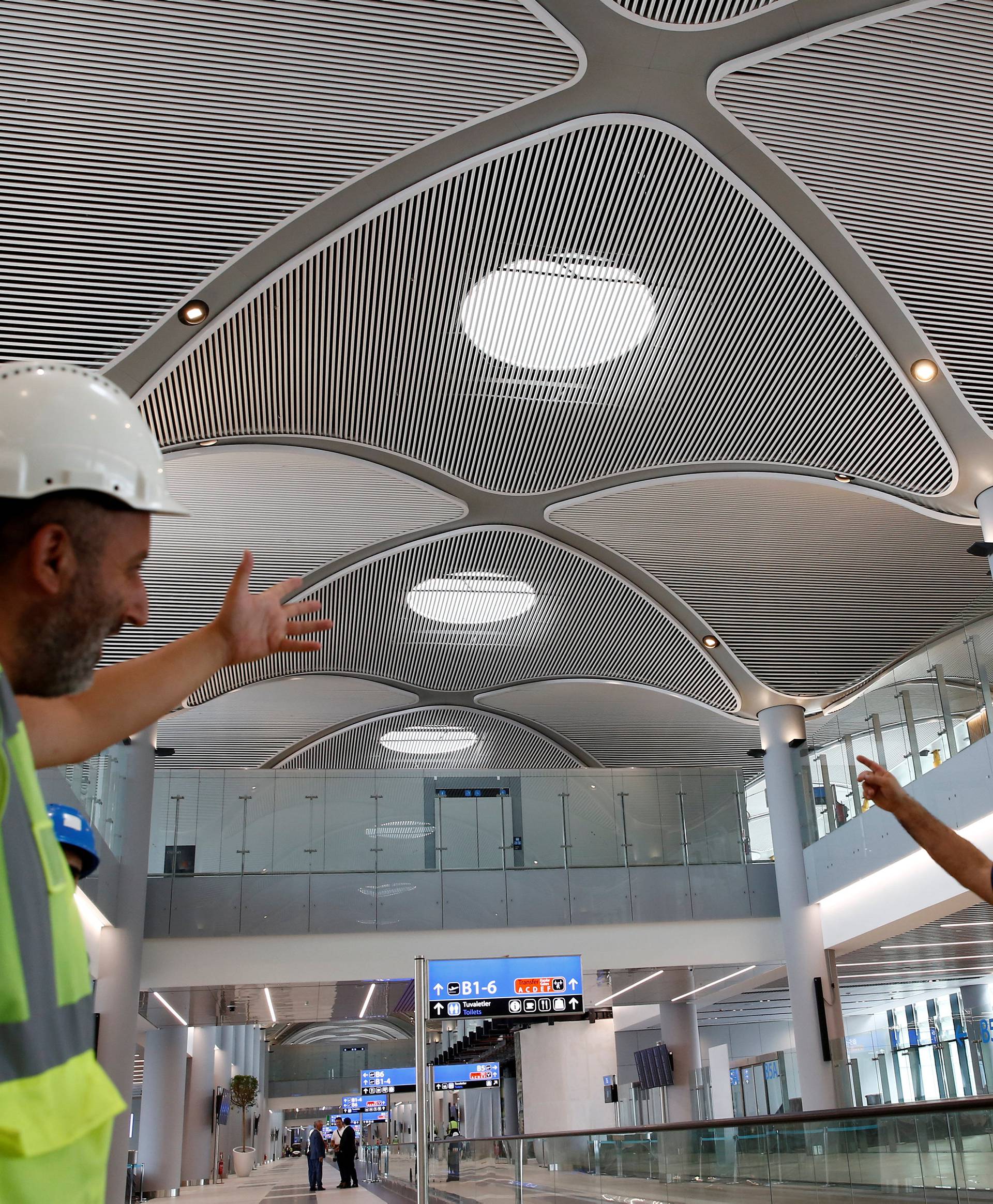 FILE PHOTO: Workers chat at the international terminal of the city's new airport under construction in Istanbul