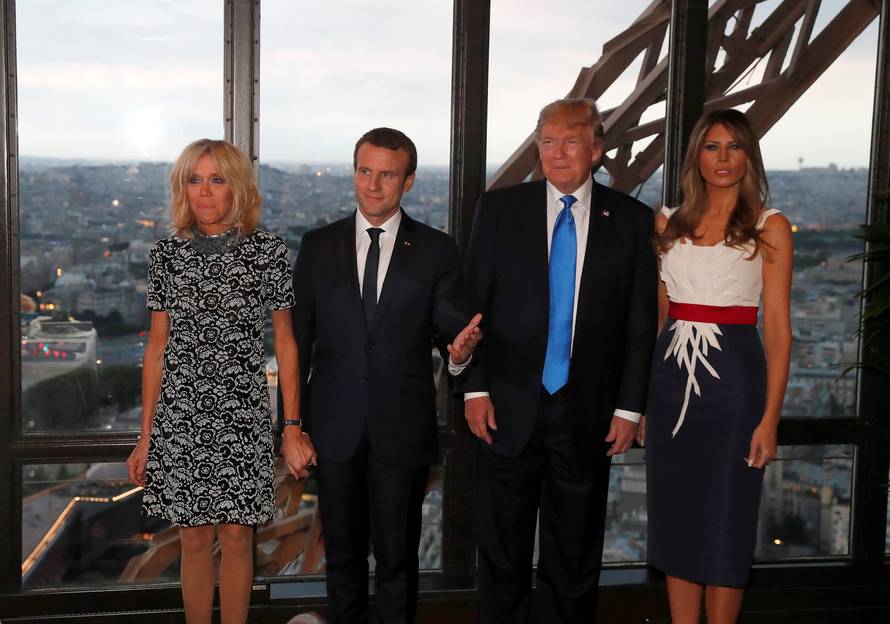 From L-R, Brigitte Macron, wife of French President Emmanuel Macron, U.S. President Donald Trump and  First lady Melania Trump pose at the Jules Verne restaurant for a private dinner at the Eiffel Tower in Paris
