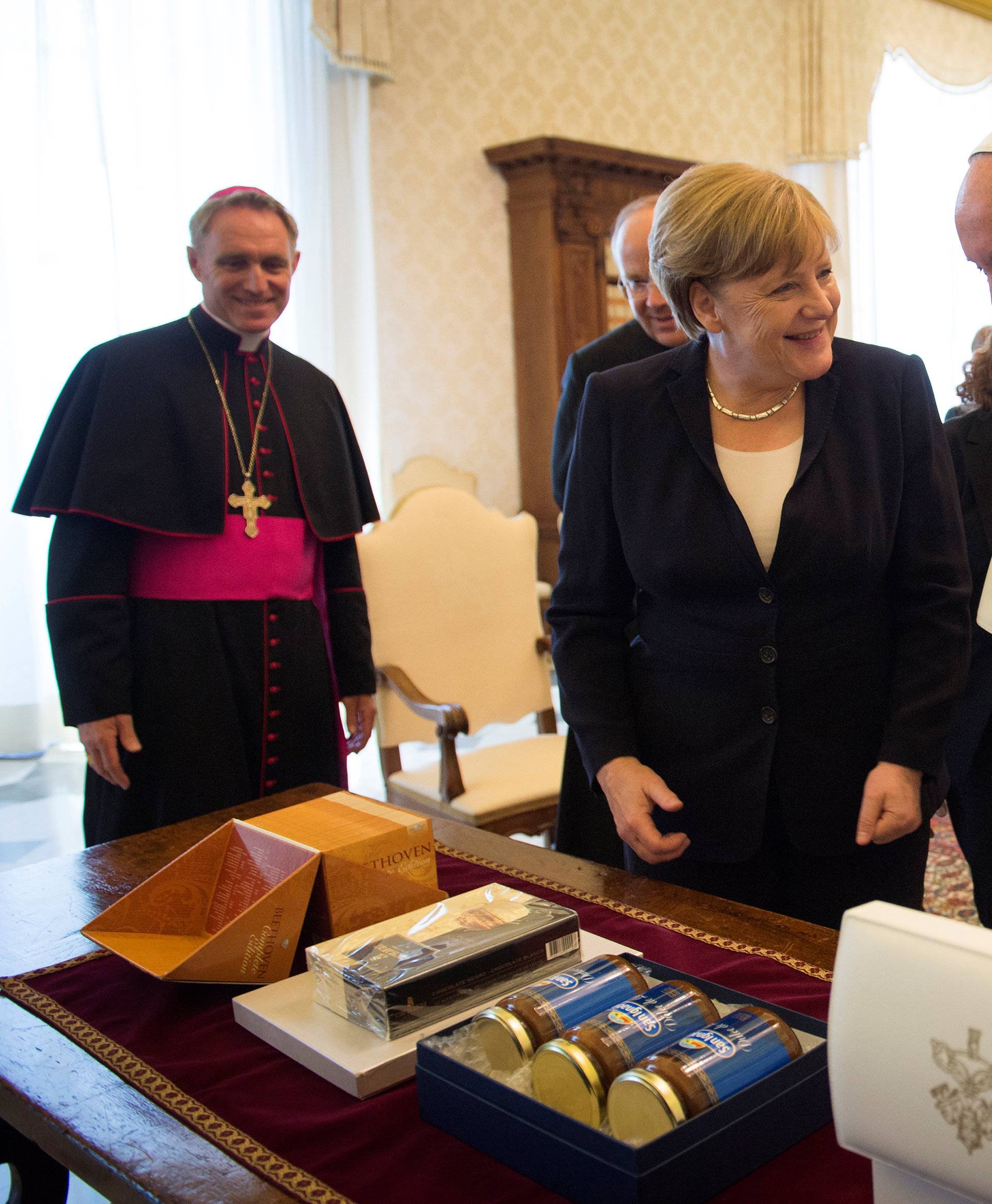 German Chancellor Angela Merkel and Pope Francis exchange gifts during a meeting at the Vatican