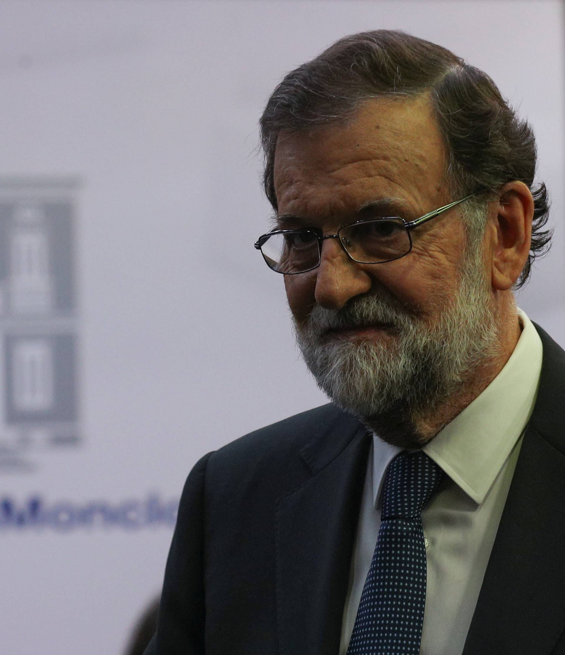 Spain's PM Rajoy leaves the conference room after delivering a statement at the Moncloa Palace in Madrid