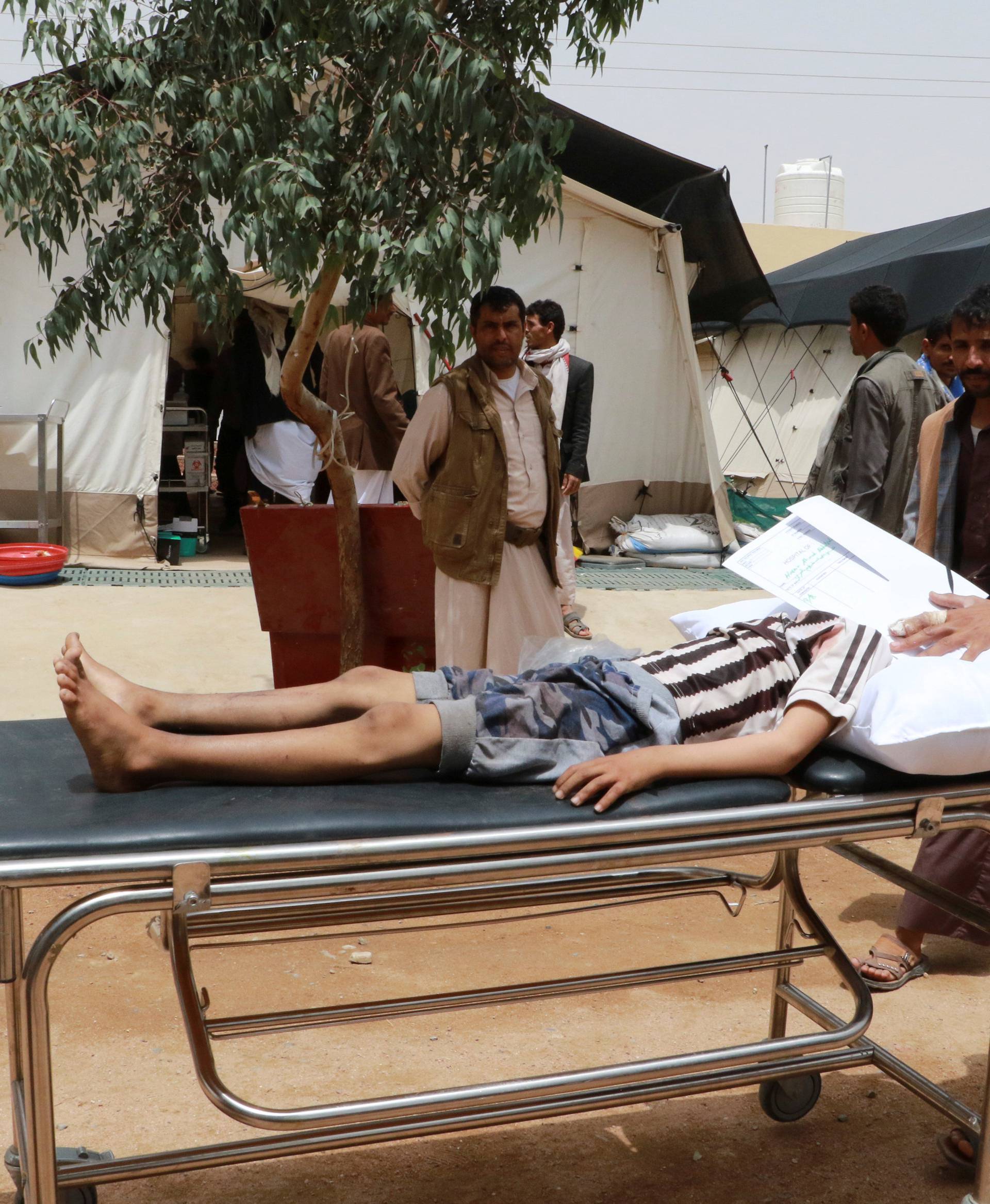 A Yemeni boy lies on at stretcher after being injured by an airstrike in Saada